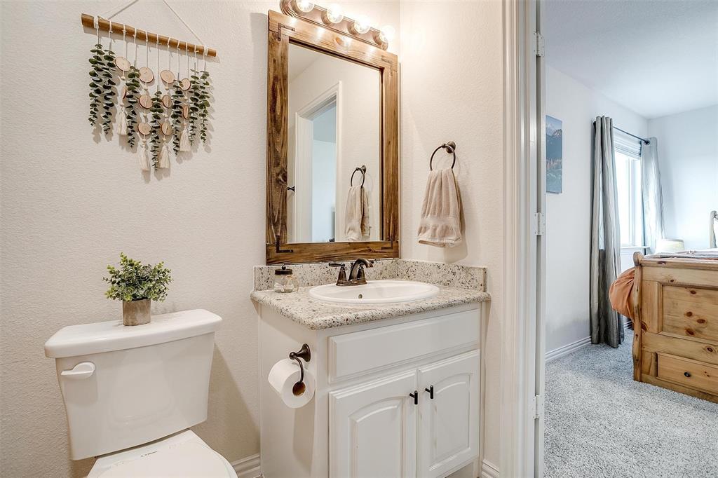 340 Sanger Drive Springtown, TX 76082 - Photo 29 of 38 a bathroom with a toilet sink and mirror