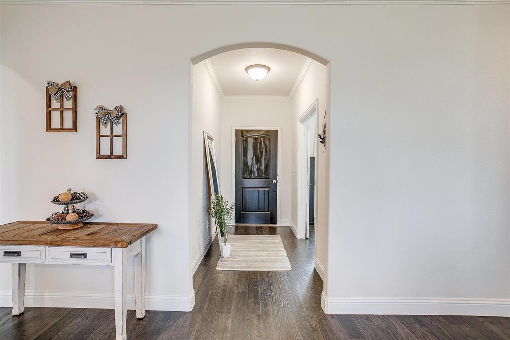 340 Sanger Drive Springtown, TX 76082 - Photo 4 of 38 a view of a hallway view with wooden floor and staircase