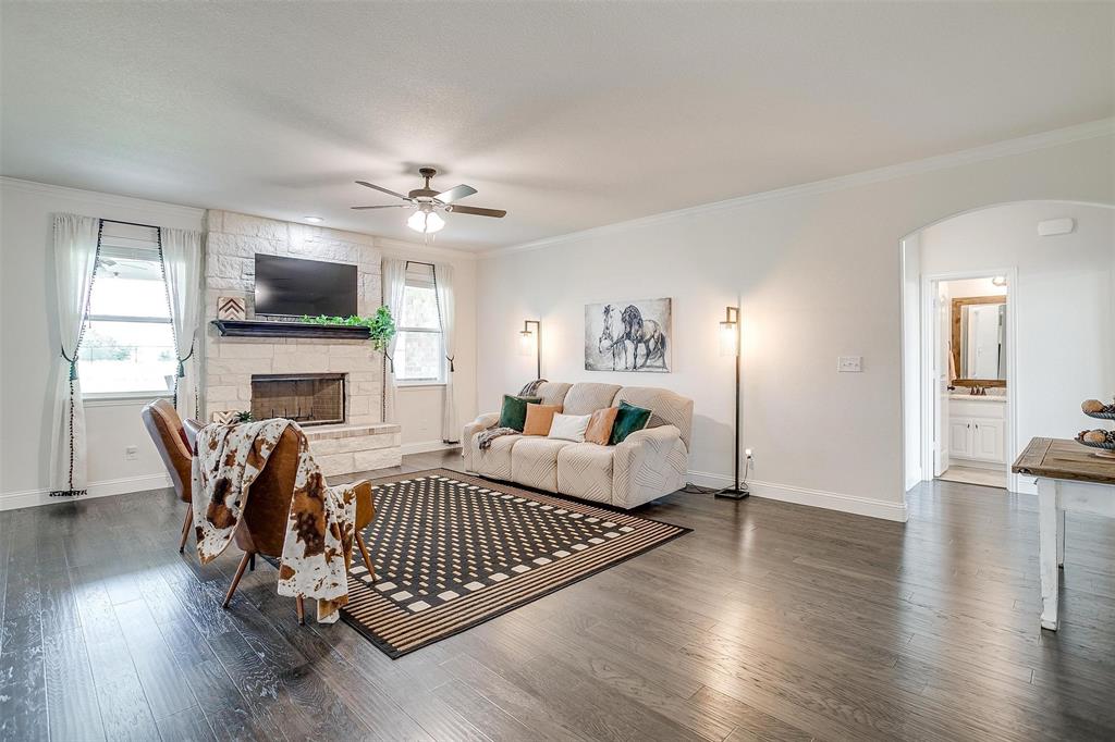 340 Sanger Drive Springtown, TX 76082 - Photo 9 of 38 a living room with furniture a flat screen tv and a fireplace