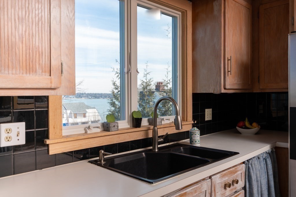 6 Governor Long Road Hingham, MA 02043 - Photo 14 of 24 a kitchen with a sink a counter top space and a large window