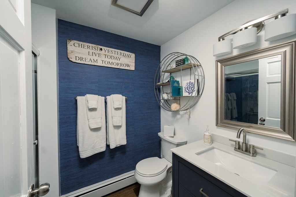 6 Governor Long Road Hingham, MA 02043 - Photo 15 of 24 a bathroom with a toilet a sink and mirror