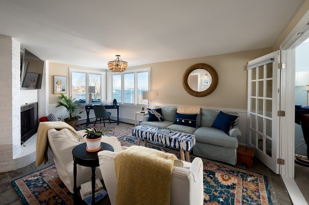 6 Governor Long Road Hingham, MA 02043 - Photo 5 of 24 a living room with furniture a fireplace and a large window