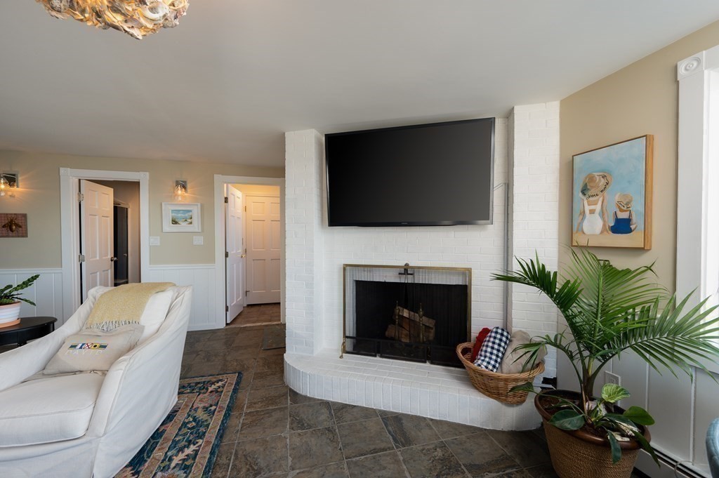 6 Governor Long Road Hingham, MA 02043 - Photo 6 of 24 a living room with furniture a fireplace and a flat screen tv