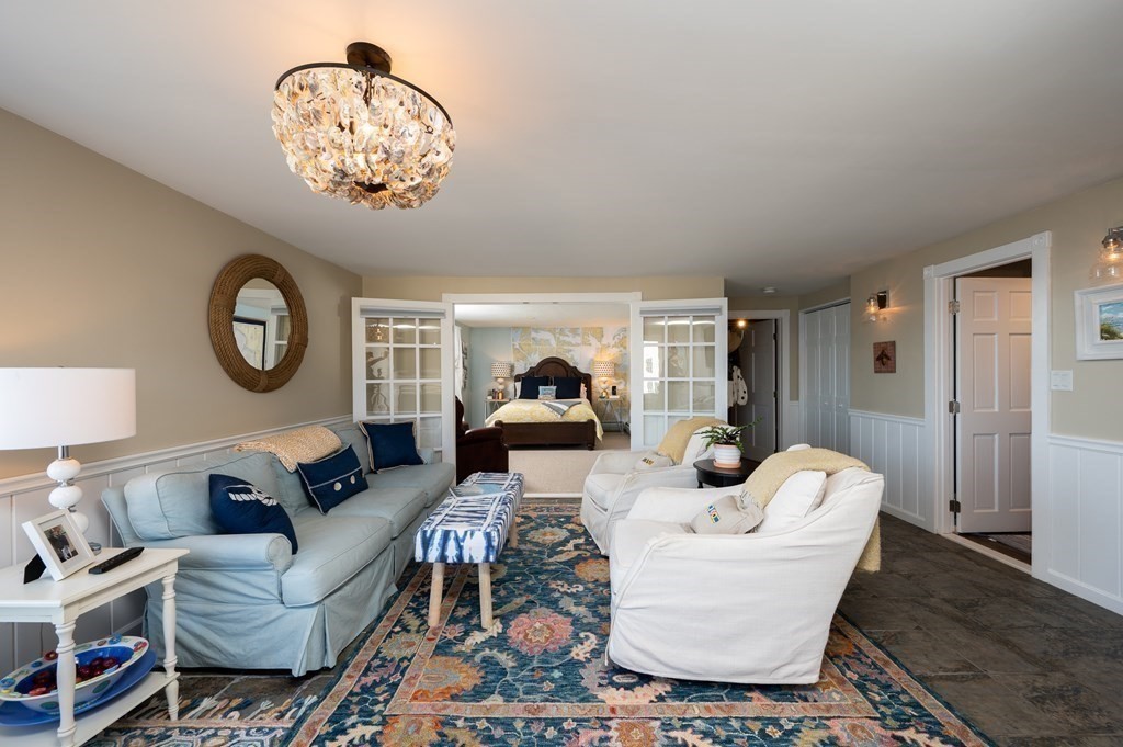 6 Governor Long Road Hingham, MA 02043 - Photo 7 of 24 a living room with furniture a clock and a chandelier