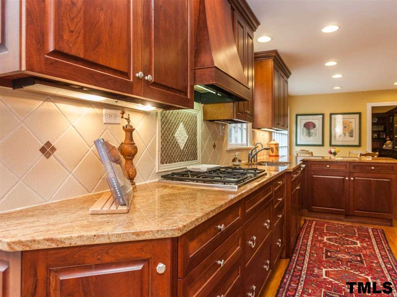 1804 Pony Run Road Raleigh, NC 27615 - Photo 11 of 25 a kitchen with stainless steel appliances granite countertop a sink stove and cabinets