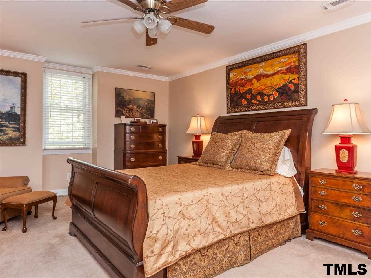 1804 Pony Run Road Raleigh, NC 27615 - Photo 13 of 25 a bedroom with a bed and dresser with mirror