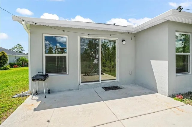 a view of a house with backyard porch and garden