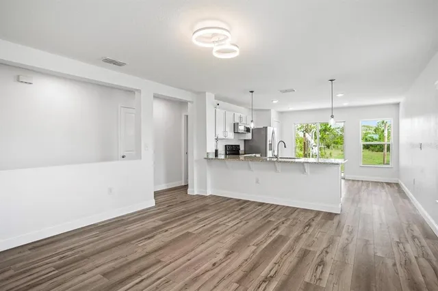 a view of kitchen with cabinets and wooden floor