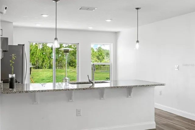 a view of an empty room with a window and ceiling fan