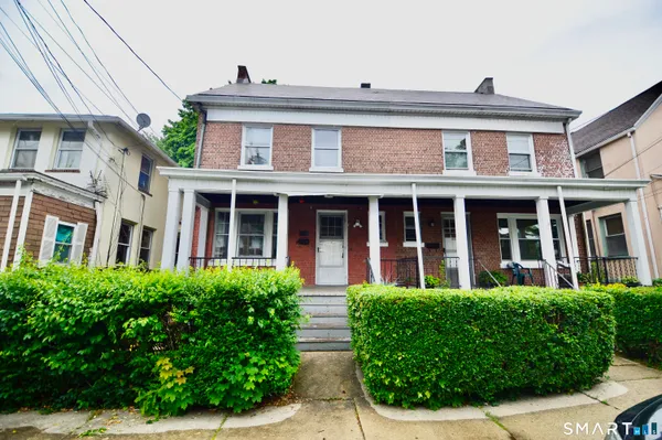 front view of a brick house with a large window