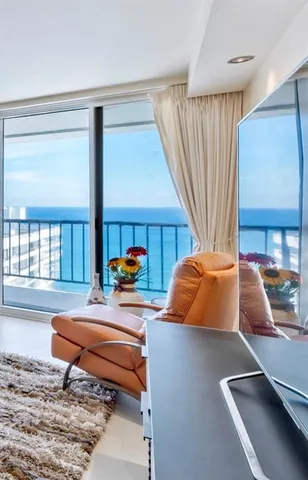 a living room with furniture a window and a flat screen tv