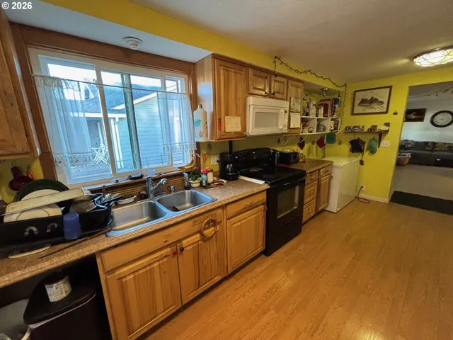 a kitchen with a sink appliances and cabinets