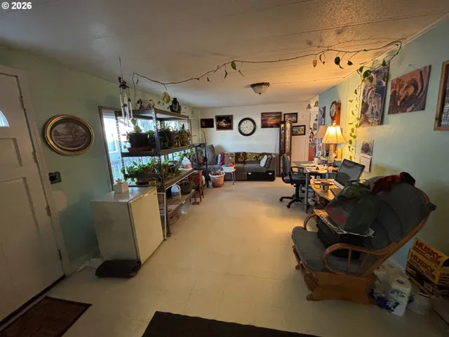 a living room with furniture and a clock