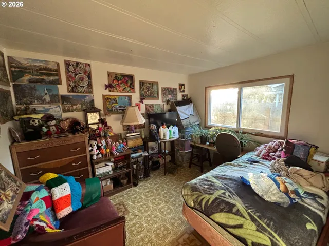 a bedroom with a bed furniture and a window