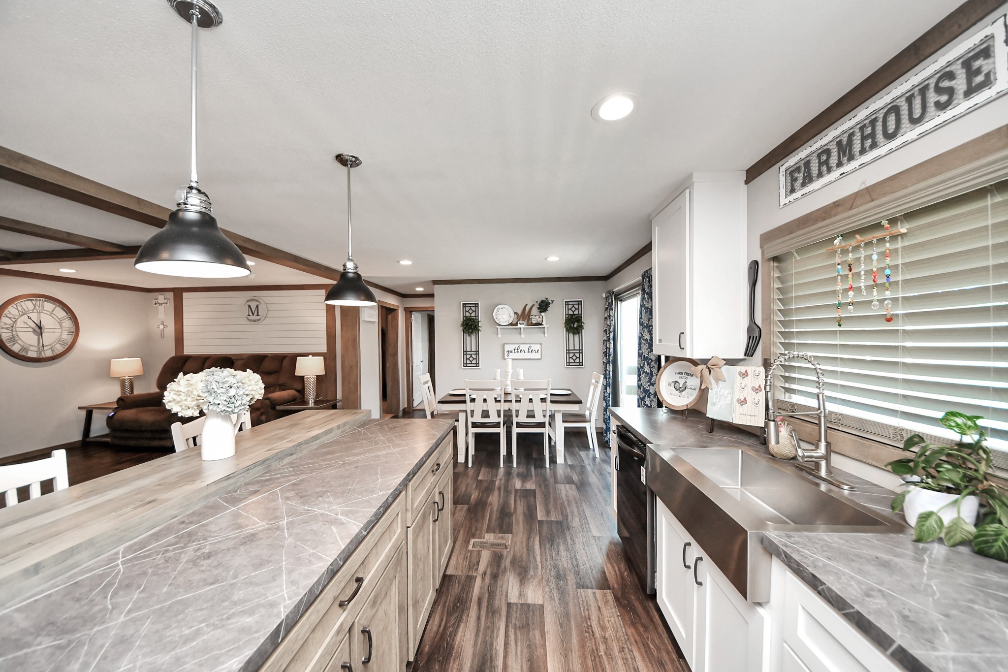 131 Kiowa Court Rosharon, TX 77583 - Photo 4 of 42 This kitchen features a beautiful farmhouse design with a spacious island, countertops, and pendant lighting. It opens to a cozy dining area and comfortable living space, perfect for family gatherings.