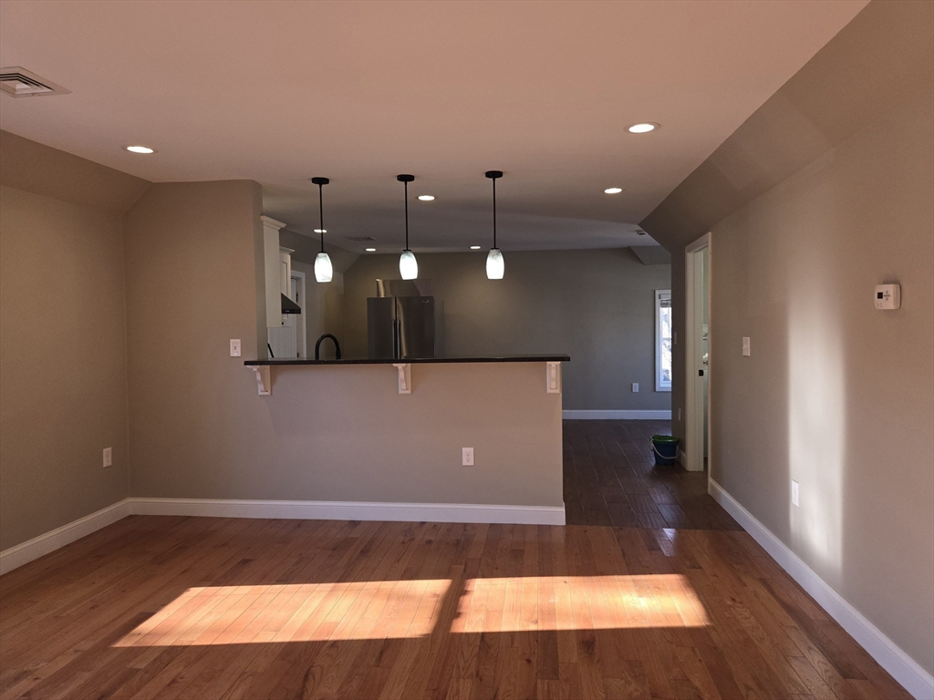 3 Pearl Street, Unit 2 Stoneham, MA 02180 - Photo 12 of 21 a view of a livingroom with furniture and wooden floor