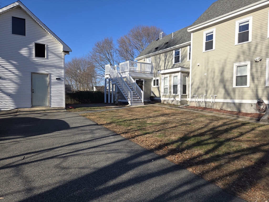 3 Pearl Street, Unit 2 Stoneham, MA 02180 - Photo 2 of 21 a view of a house with a swimming pool