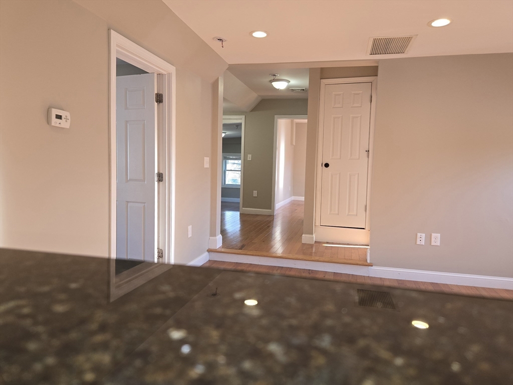 3 Pearl Street, Unit 2 Stoneham, MA 02180 - Photo 9 of 21 a view of a livingroom with wooden floor and a cabinet