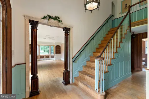 a view of entryway and hall with wooden floor