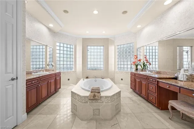 a large bathroom with a granite countertop tub sink and mirror