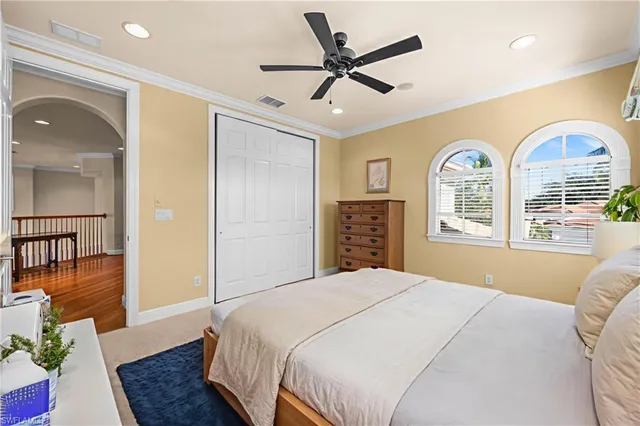 a bedroom with a bed and a large window