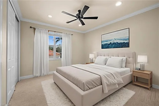 a bedroom with a large bed and a ceiling fan