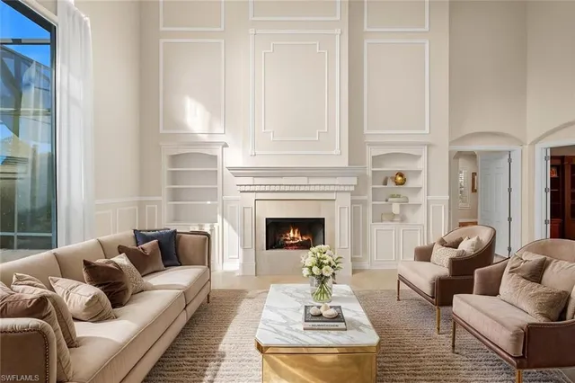 a living room with furniture fireplace and a table