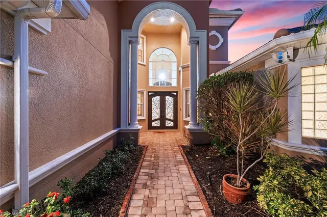 a view of a pathway of a house with a flower garden