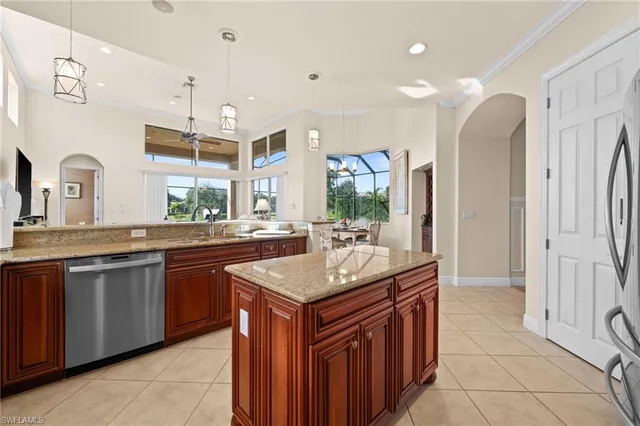 a kitchen with granite countertop a sink and a refrigerator