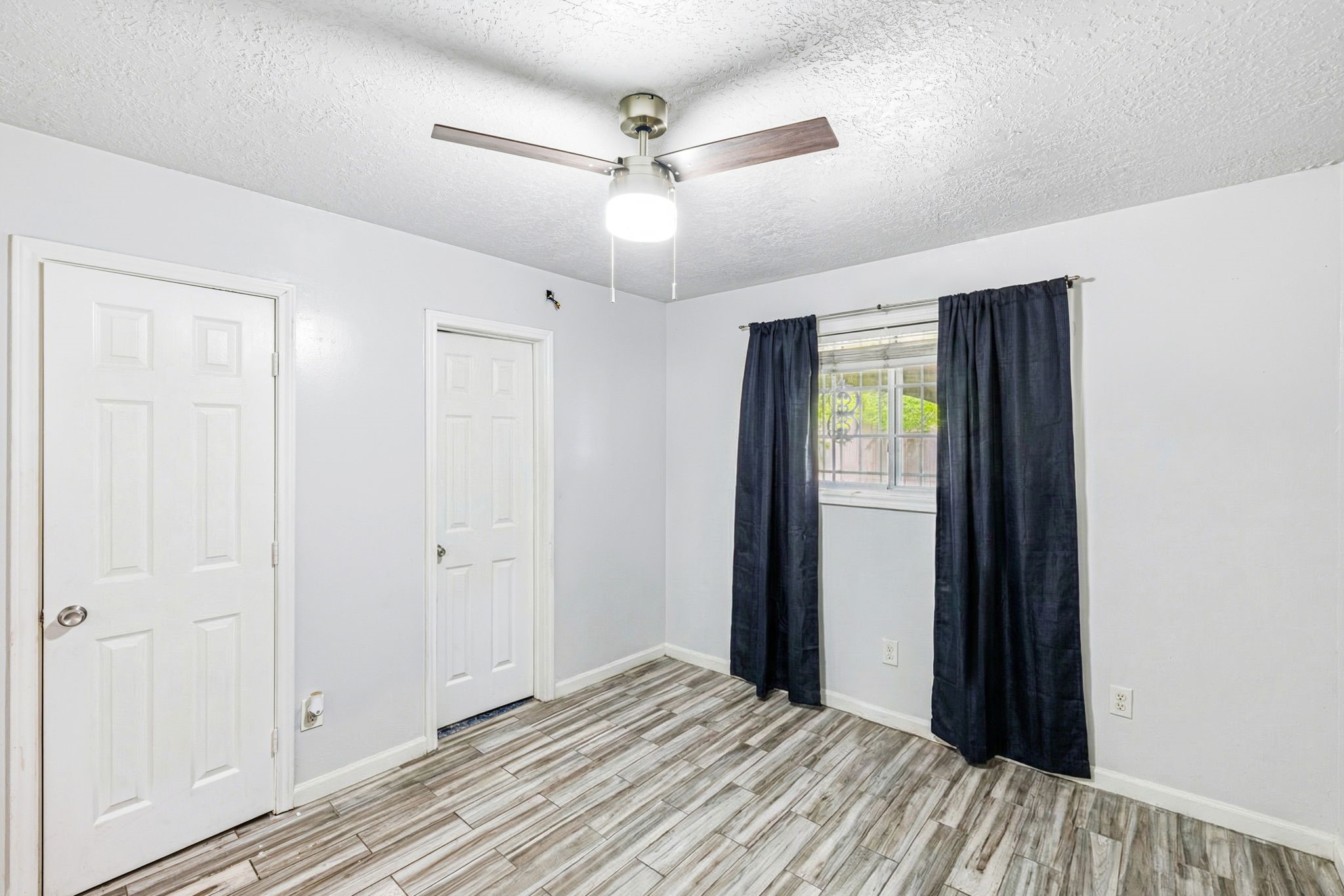 4422 Sandydale Lane Houston, TX 77039 - Photo 16 of 36 a view of a livingroom with a ceiling fan and wooden floor