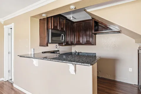 a kitchen with stainless steel appliances granite countertop a sink and a microwave oven