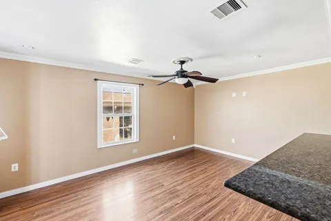 wooden floor in an empty room with a window