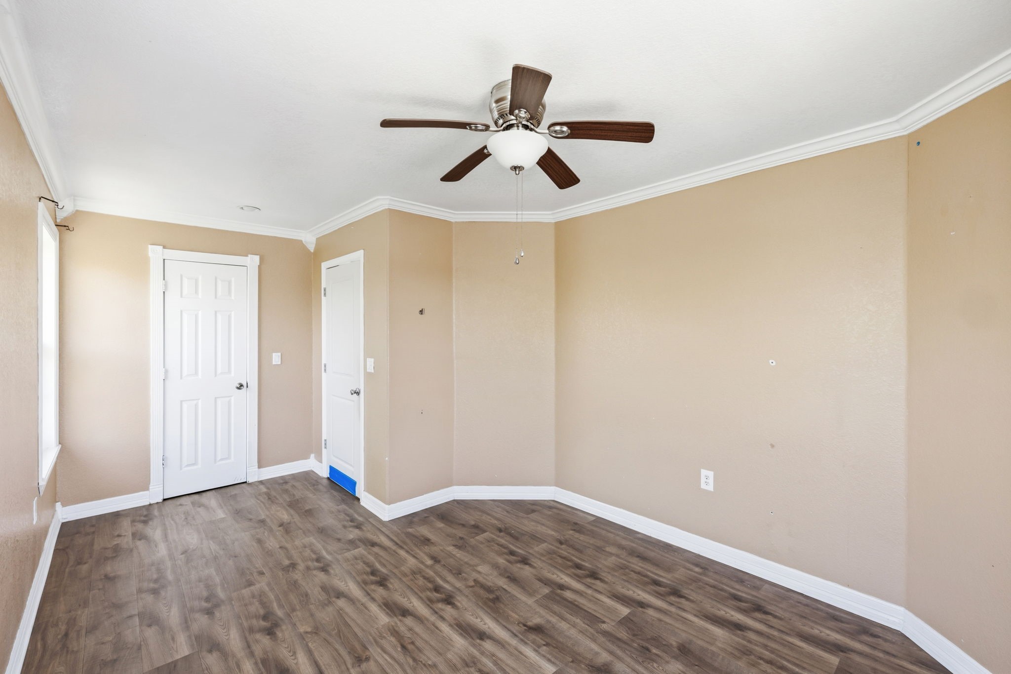 4422 Sandydale Lane Houston, TX 77039 - Photo 31 of 36 a view of a room with wooden floor and a ceiling fan
