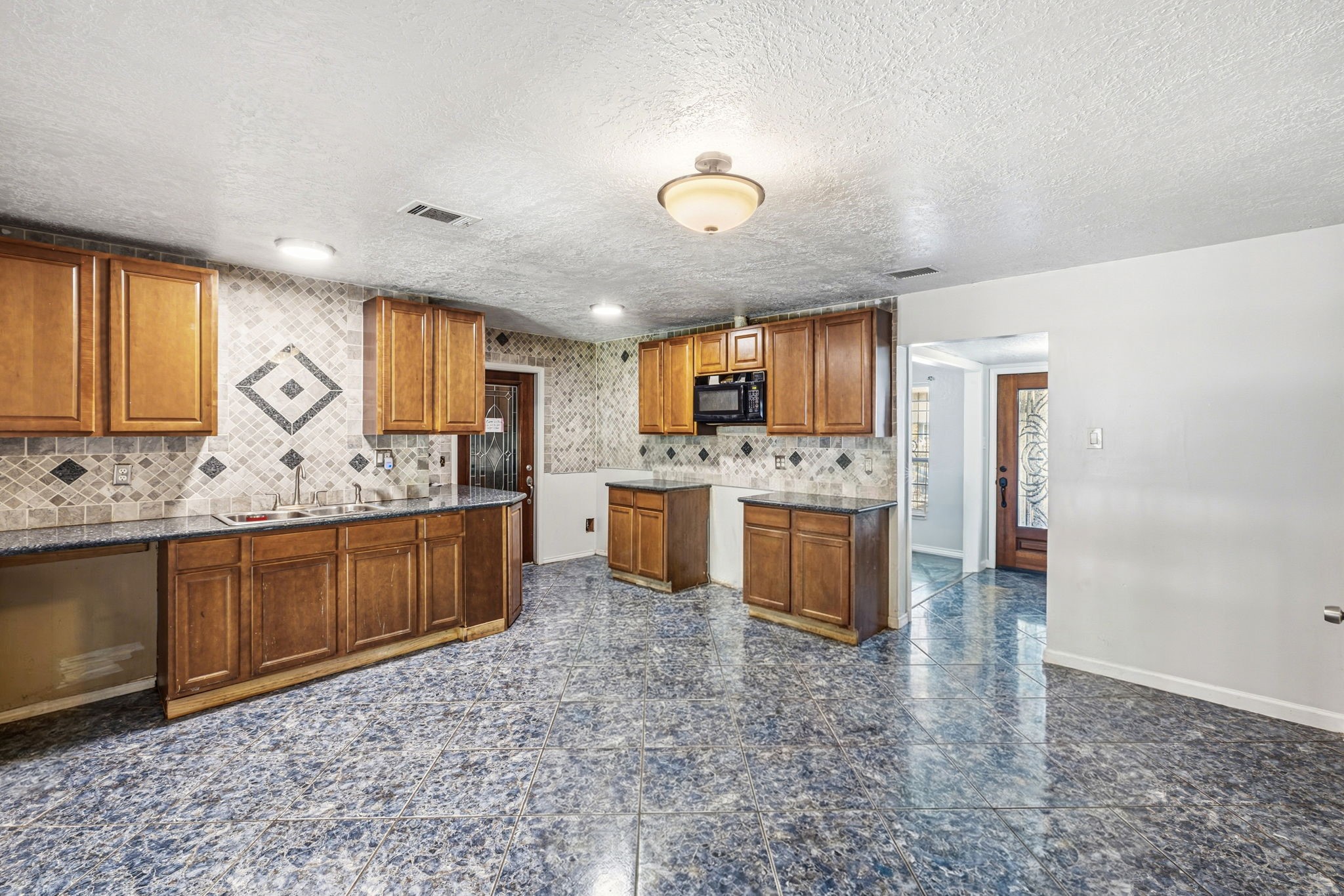4422 Sandydale Lane Houston, TX 77039 - Photo 6 of 36 a large kitchen with a sink and cabinets
