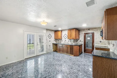 a view of a kitchen with a large window