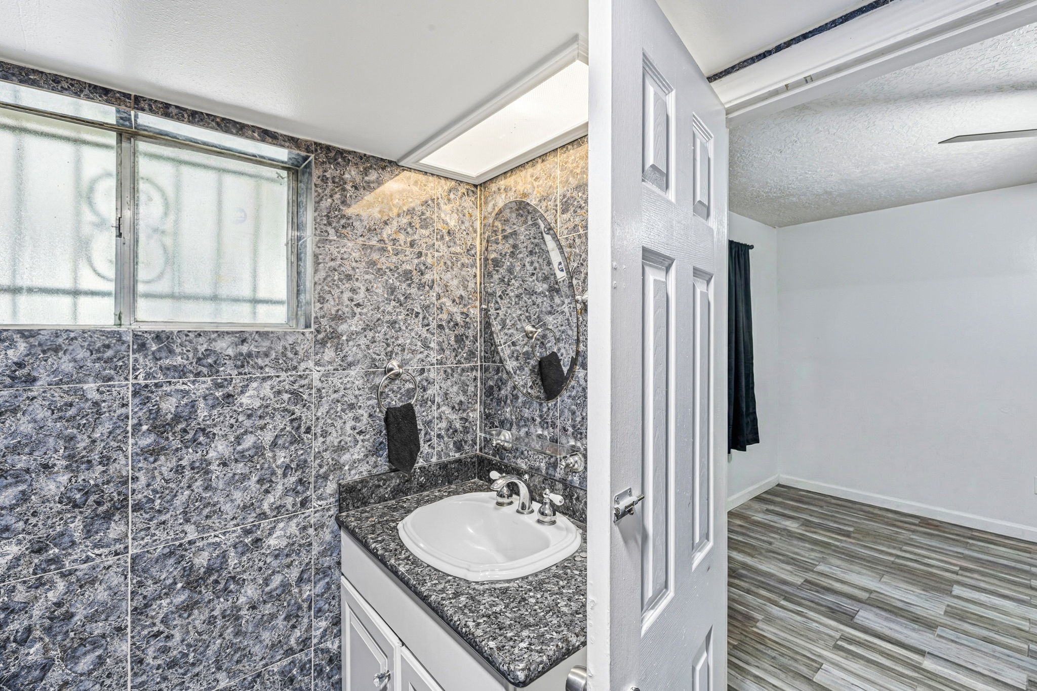 4422 Sandydale Lane Houston, TX 77039 - Photo 10 of 36 a bathroom with a granite countertop sink and a mirror