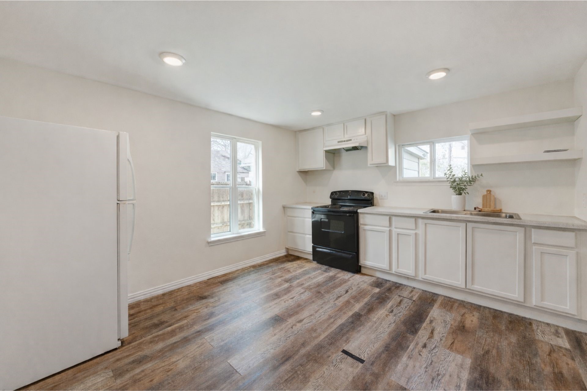 7019 Bonham Street Houston, TX 77020 - Photo 4 of 17 a kitchen with granite countertop white cabinets and stainless steel appliances