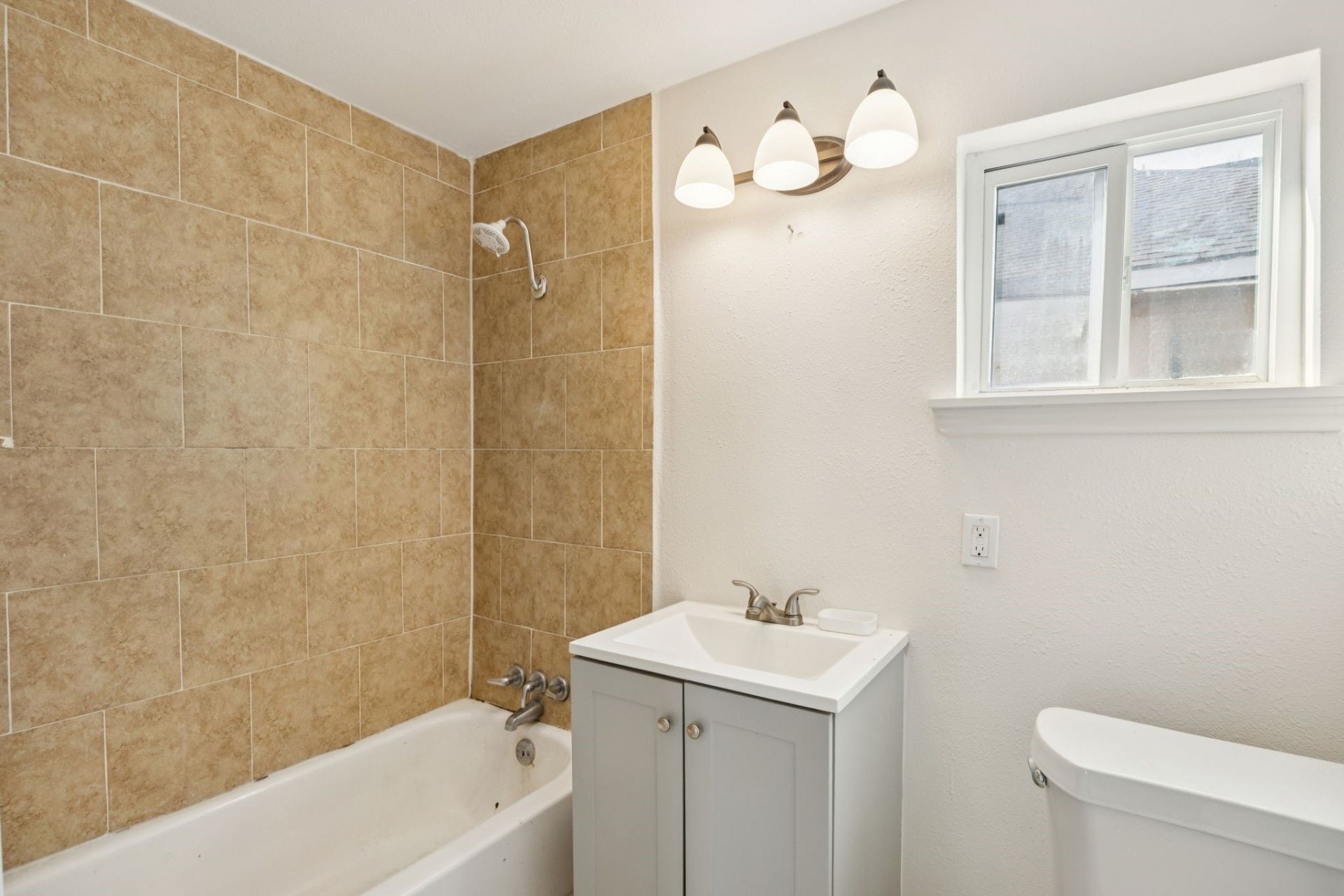 7019 Bonham Street Houston, TX 77020 - Photo 8 of 17 a bathroom with a sink a toilet and shower