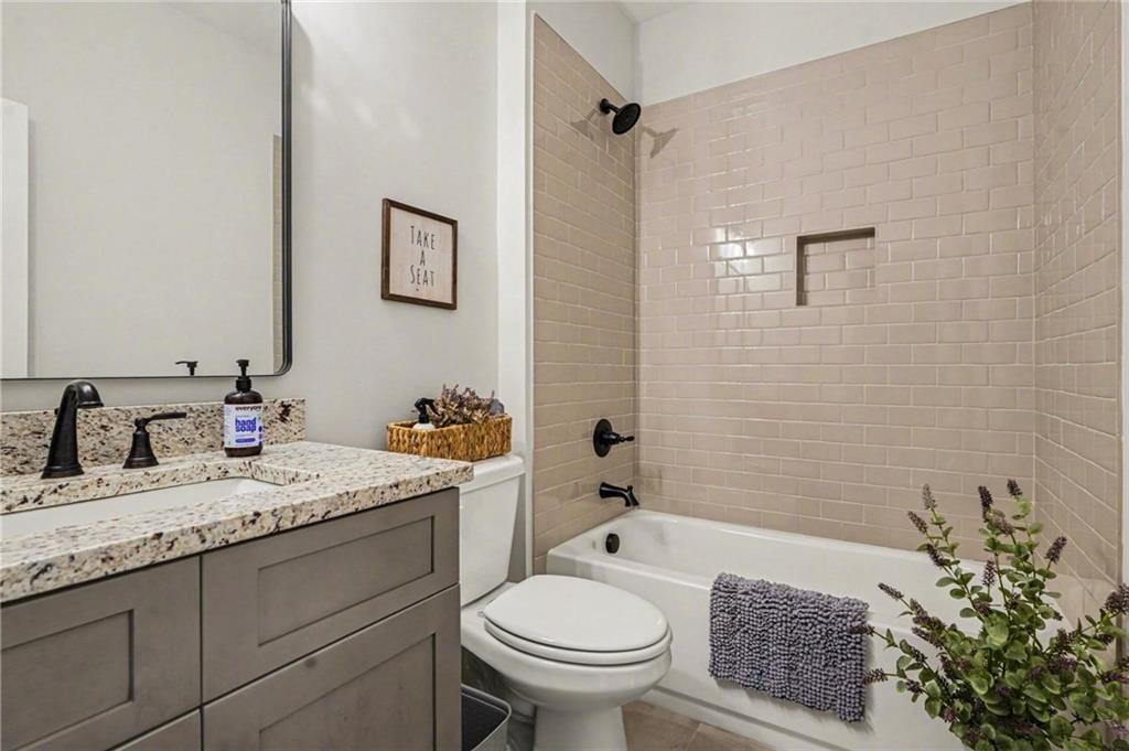 287 Conner Lane Williamson, GA 30292 - Photo 14 of 33 a bathroom with a granite countertop toilet sink and mirror