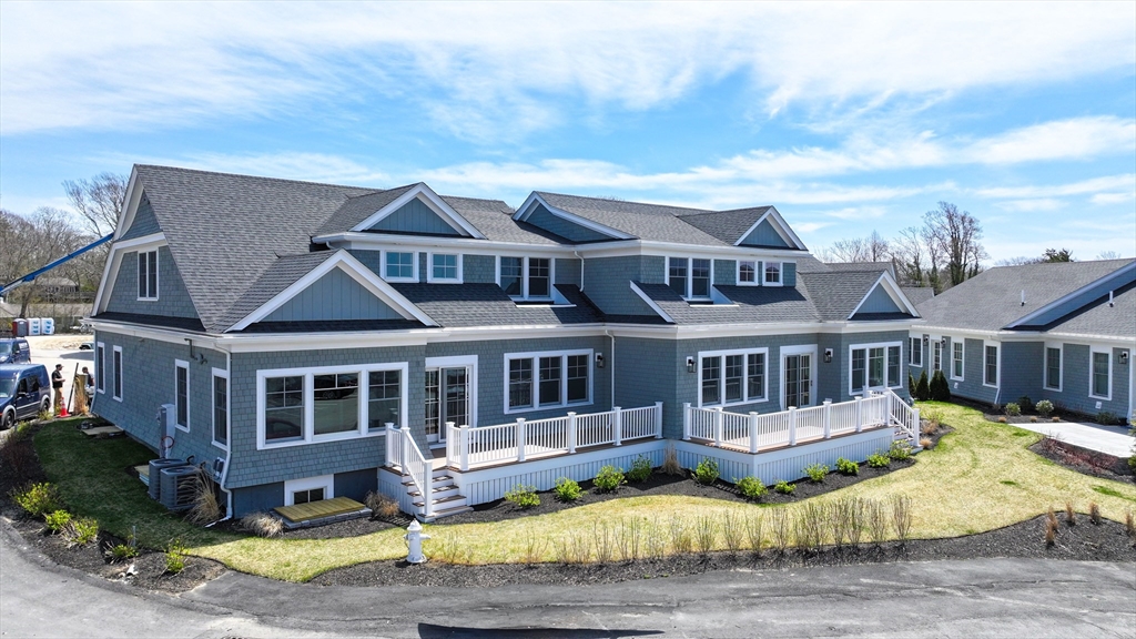 a view of a house with a small yard and wooden fence