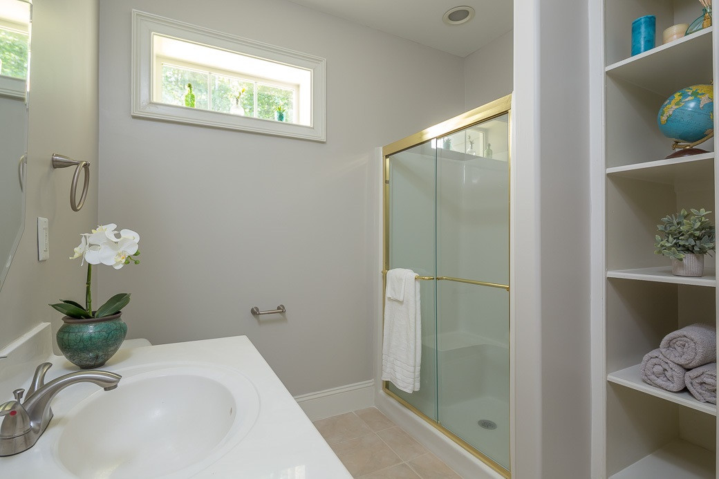 4901 Grilse Way Raleigh, NC 27613 - Photo 13 of 19 Private bath for one of the secondary bedrooms with new paint, built-in shelves and lots of natural light. BATHROOM
