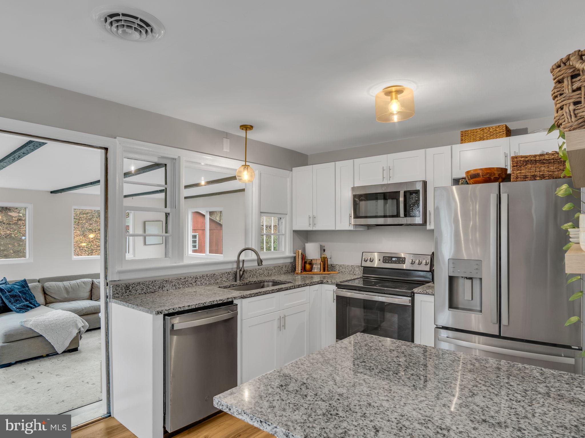 3500 Centerfield Road Harrisburg, PA 17109 - Photo 11 of 32 a kitchen with stainless steel appliances granite countertop a sink stove and refrigerator