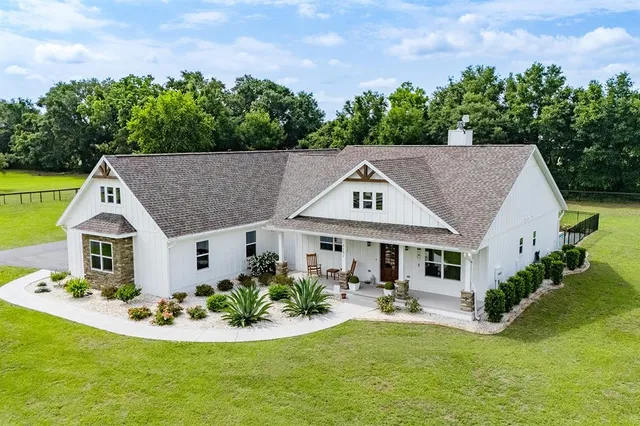 a aerial view of a house with swimming pool and garden