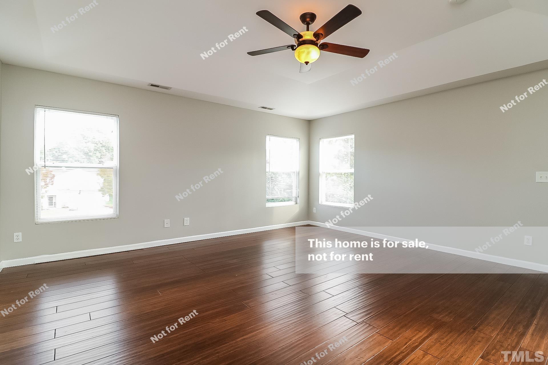 115 Cinder Cross Way Garner, NC 27529 - Photo 14 of 27 a view of an empty room with a window and wooden floor