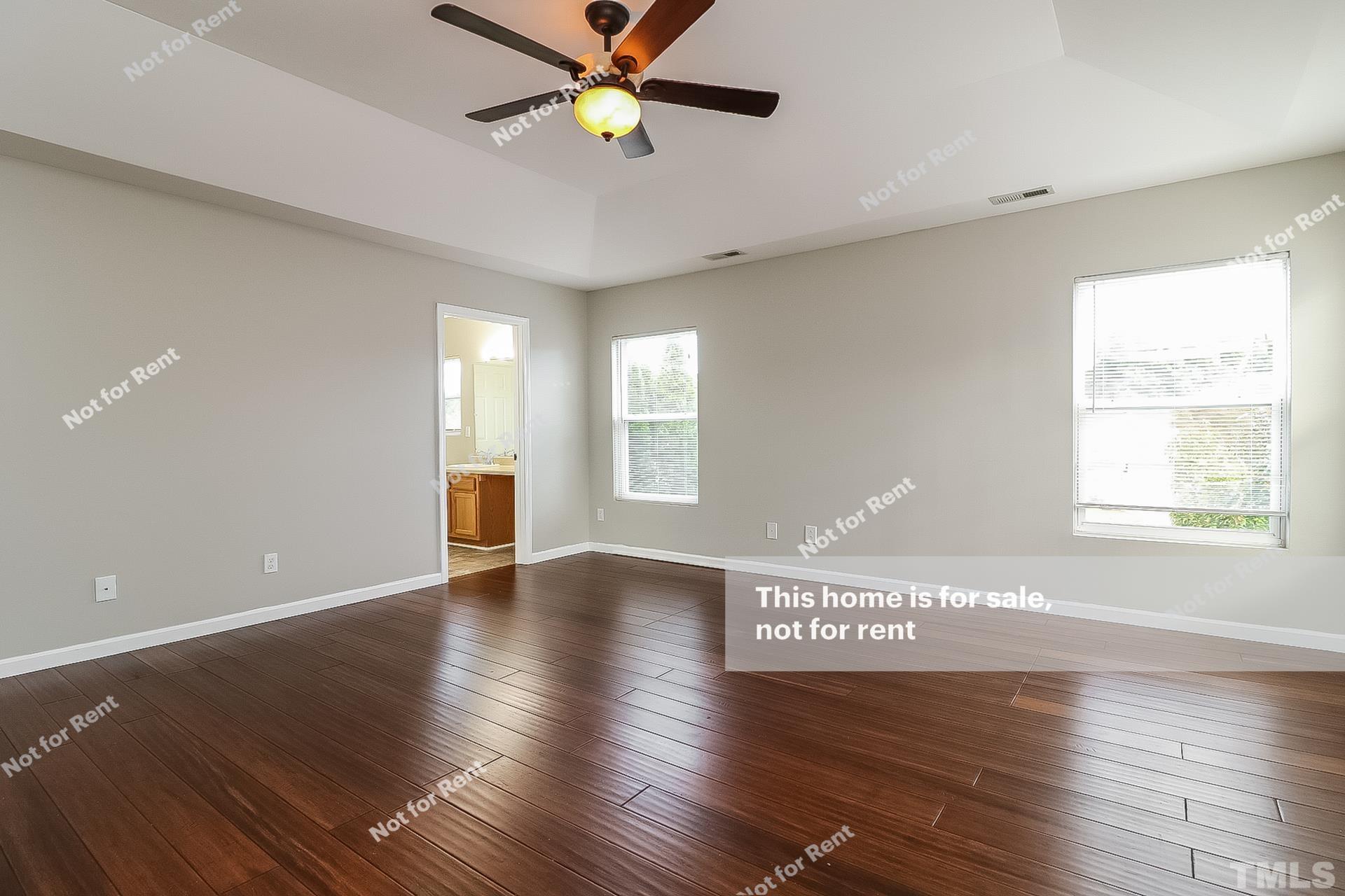 115 Cinder Cross Way Garner, NC 27529 - Photo 15 of 27 a view of an empty room with window and wooden floor