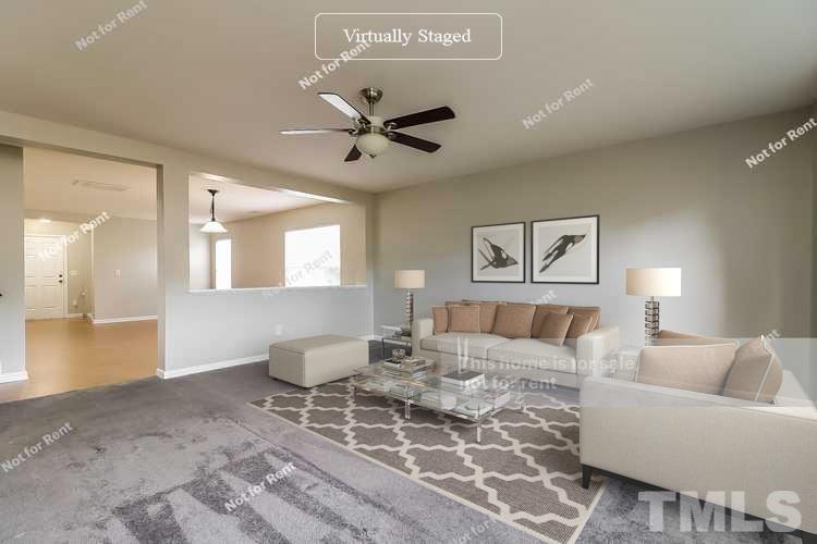 115 Cinder Cross Way Garner, NC 27529 - Photo 3 of 27 a living room with furniture a ceiling fan and a rug