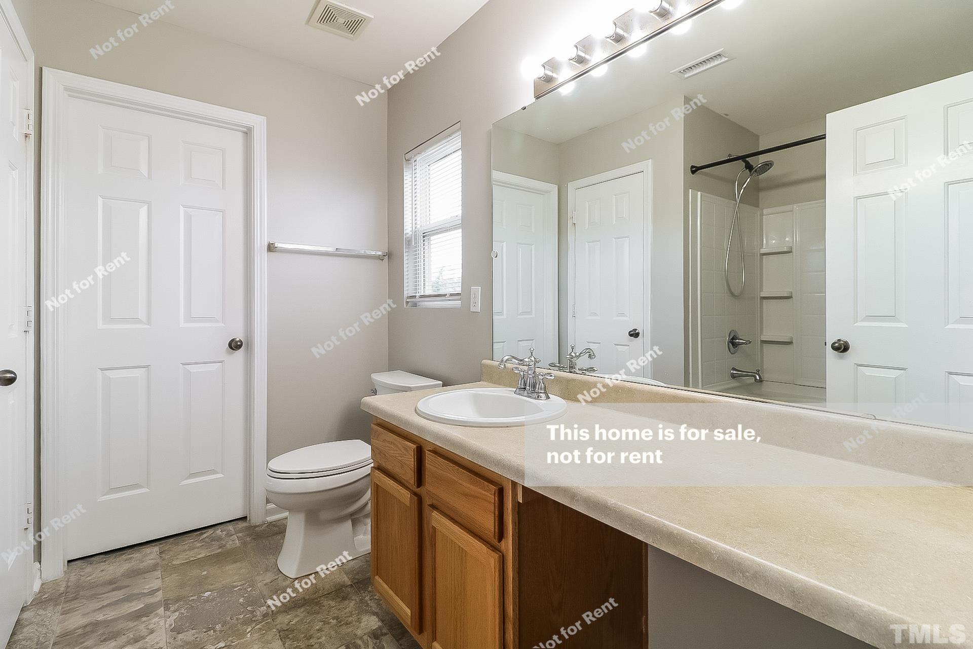 115 Cinder Cross Way Garner, NC 27529 - Photo 24 of 27 a bathroom with a granite countertop sink a toilet and a mirror