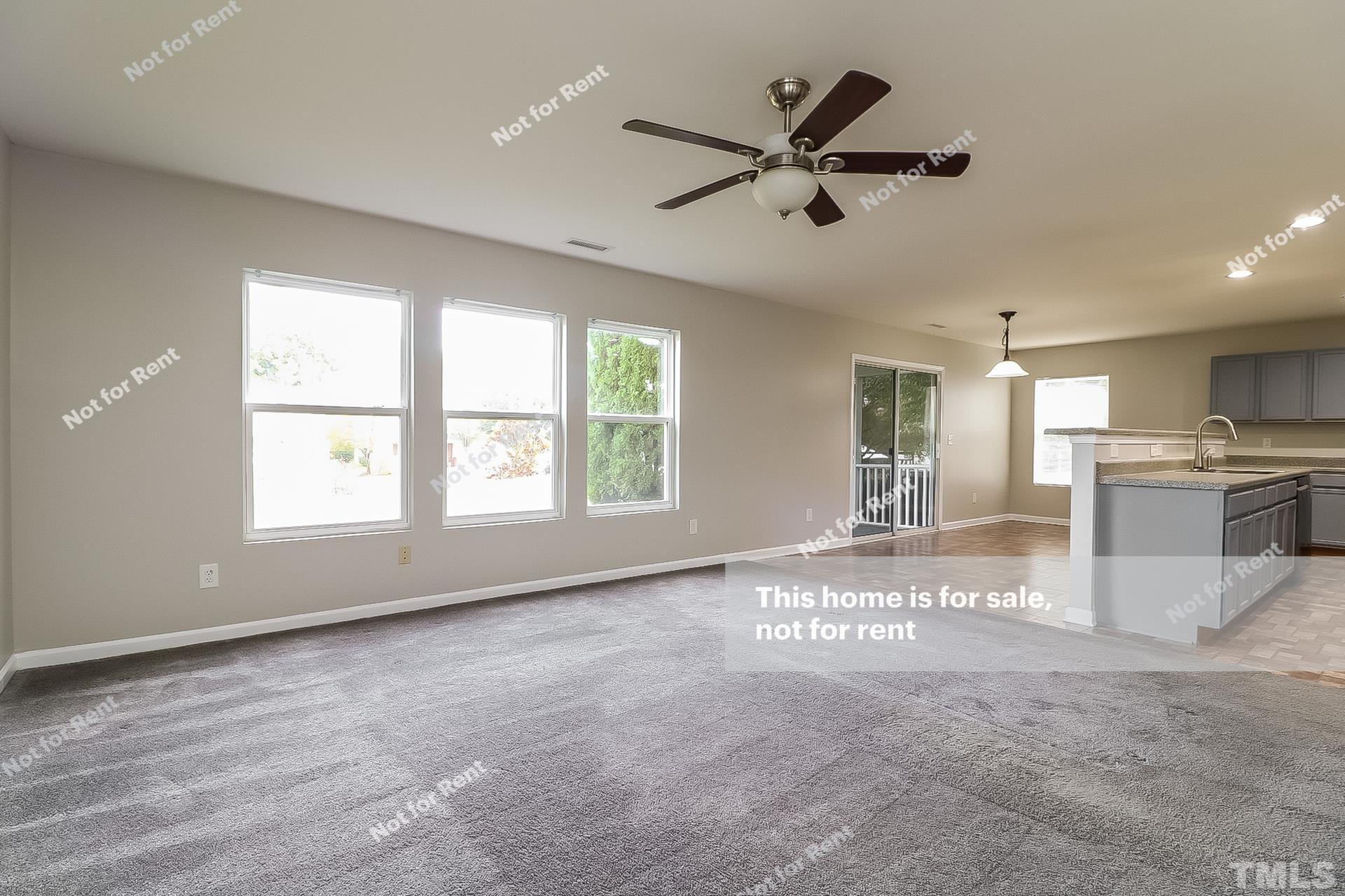 115 Cinder Cross Way Garner, NC 27529 - Photo 5 of 27 a view of an empty room with window and a kitchen