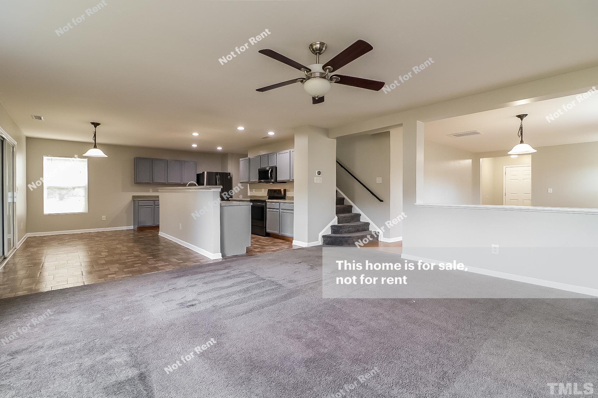 115 Cinder Cross Way Garner, NC 27529 - Photo 6 of 27 a view of a kitchen with a stove cabinets and a ceiling fan