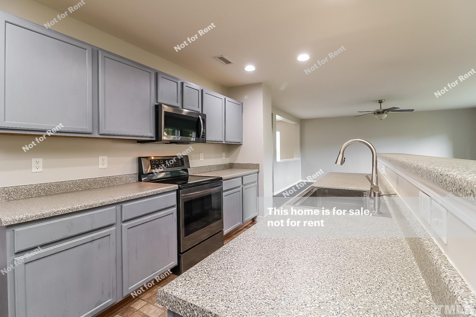 115 Cinder Cross Way Garner, NC 27529 - Photo 7 of 27 a kitchen with granite countertop white cabinets and stainless steel appliances